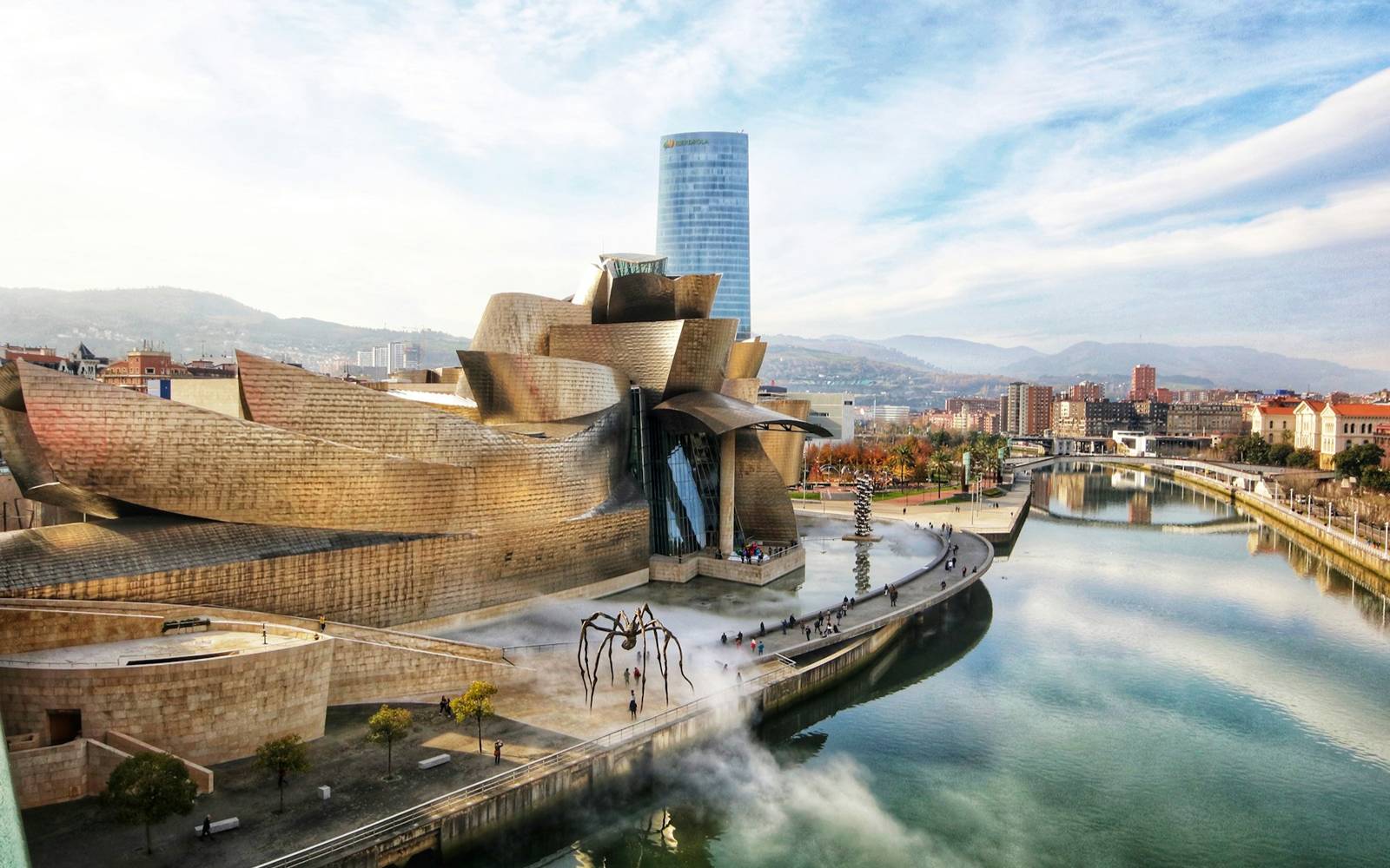 The Guggenheim Museum Bilbao - Frank Gehry's titanium curves alongside the Nervión river, with Louise Bourgeois's Maman spider sculpture on the plaza