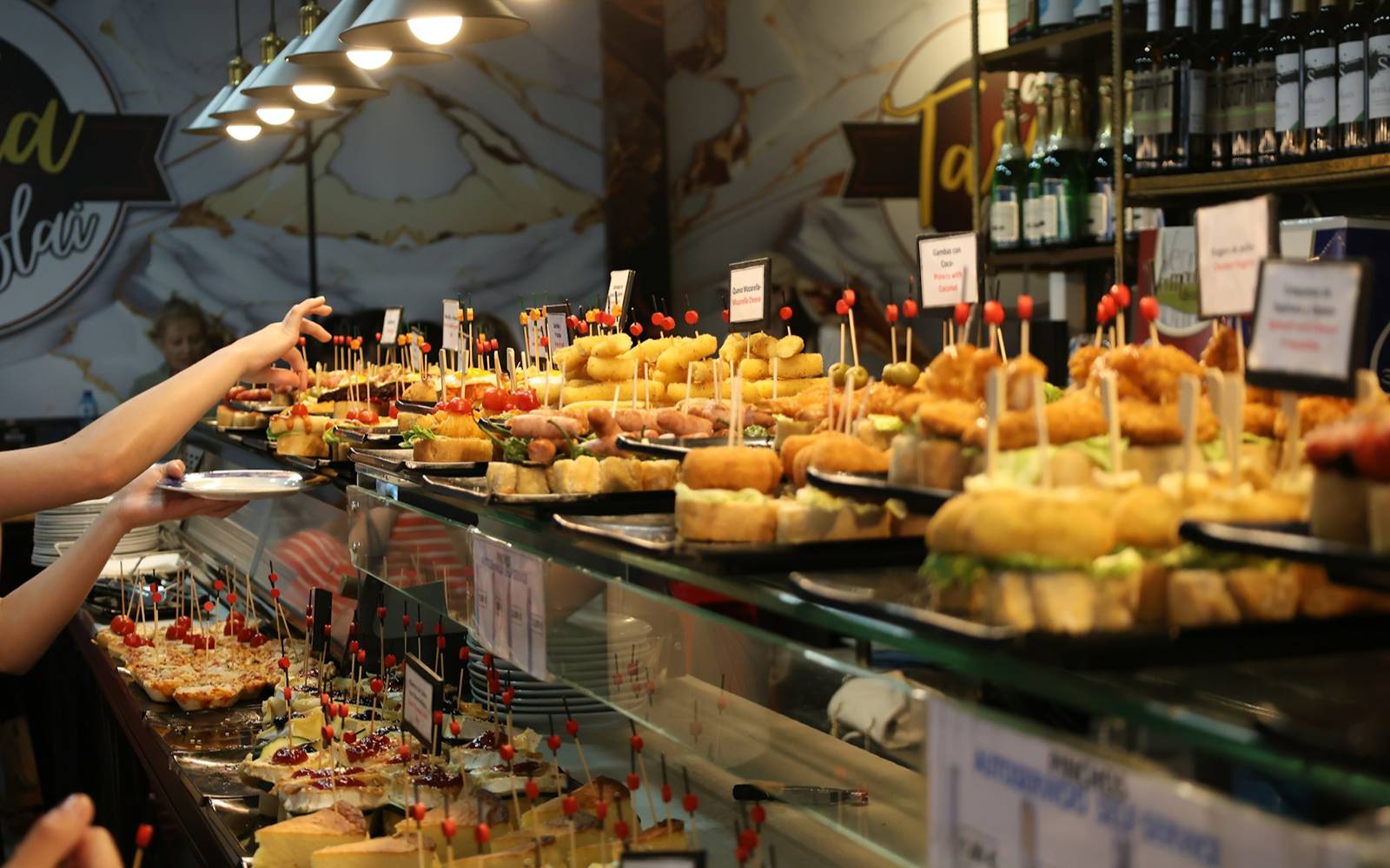 A pintxos bar counter in San Sebastián, stacked with plates of pintxos ready for the evening crawl